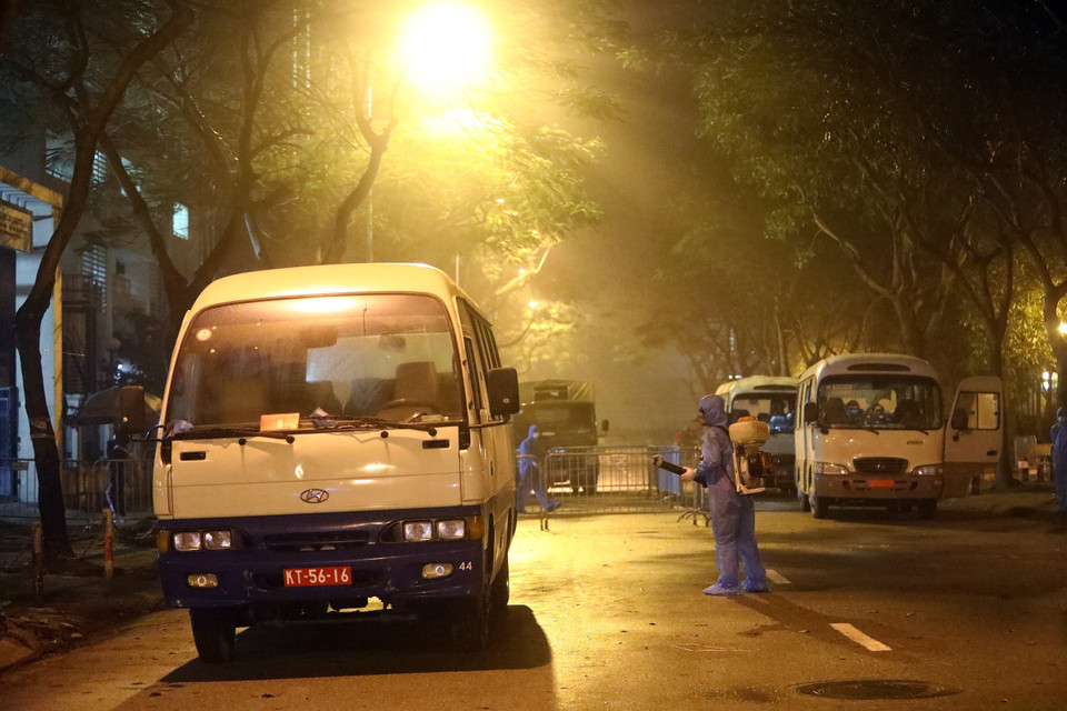 Sau khi vận chuyển người nhập cảnh từ sân bay Nội Bài về khu cách ly, xe ôtô được phun khử khuẩn, đảm bảo cho những chuyến tiếp theo. (Ảnh: Minh Quyết/TTXVN)