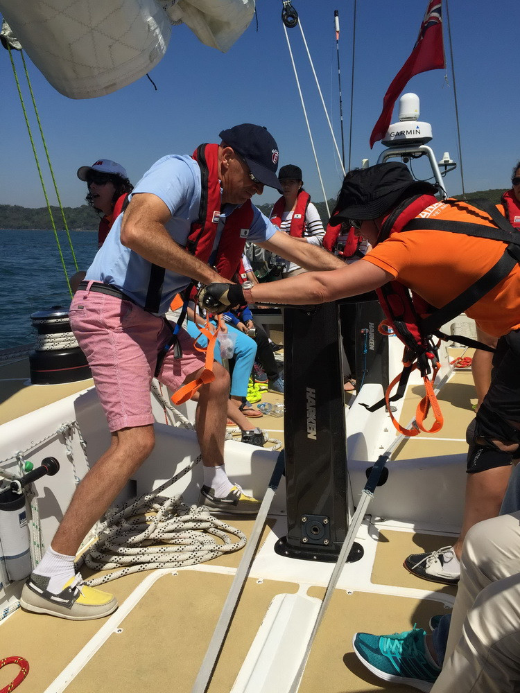 Các thuyền viên hỗ trợ nhau thu buồm. (Ảnh: Khánh Linh/Vietnam+)