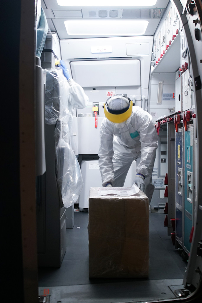 Ngay sau khi hạ cánh, hàng hoá viện trợ đã được phi hành đoàn chuyển xuống cho đại diện Trung Quốc tại sân bay Vũ Hán. (Ảnh: Vietnam+)