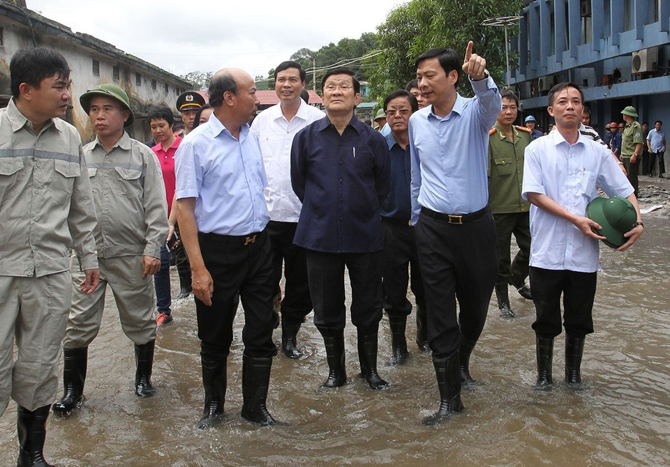 Chủ tịch nước Trương Tấn Sang kiểm tra tình hình khắc phục hậu quả do đợt mưa lũ gây ra tại Công ty than Mông Dương và tỉnh Quảng Ninh hồi tháng 8/2015. (Ảnh: Nguyễn Khang/TTXVN)