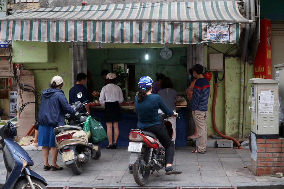 Người dân xếp hàng mua thực phẩm. (Ảnh: Vi Diệu/Vietnam+)