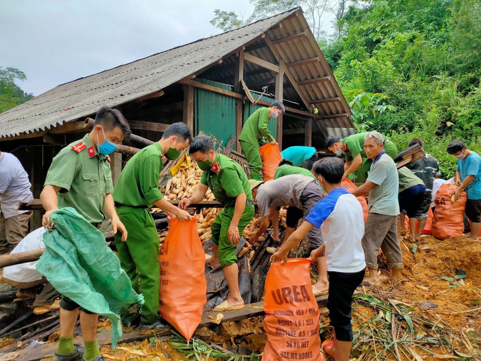 Công an huyện Na Hang (Tuyên Quang) hỗ trợ người dân thôn Khau Phiêng di dời tài sản do ảnh hưởng bởi mưa lũ và sạt lở đất (2021). (Ảnh: Nam Sương/TTXVN)