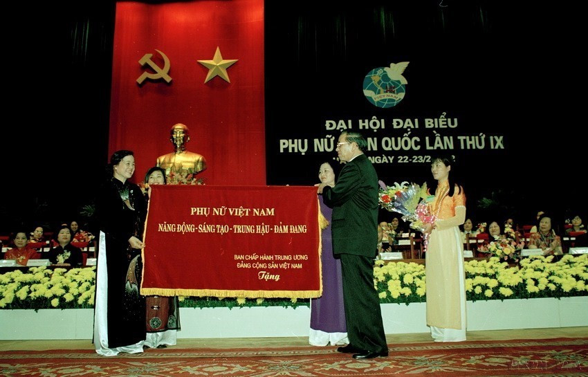 Tổng Bí thư Nông Đức Mạnh trao tặng Hội Liên hiệp Phụ nữ Việt Nam bức trướng mang dòng chữ "Phụ nữ Việt Nam: Năng động-Sáng tạo-Đảm đang" tại Đại hội đại biểu Phụ nữ toàn quốc lần thứ IX (2/2002). (Ảnh: TTXVN)