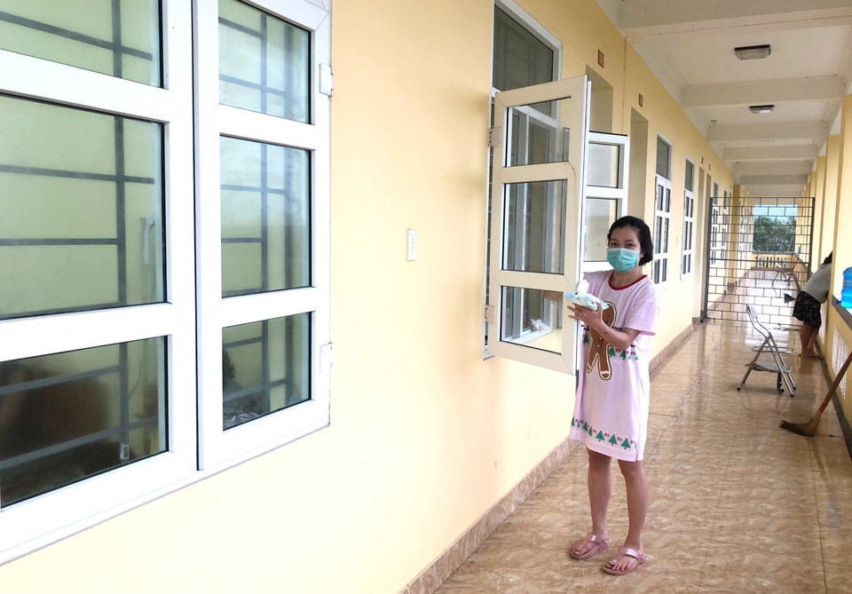 Chủ động vệ sinh lau chùi tẩy rửa các khung cửa sổ, tay nắm phòng chống dịch tại khu cách ly tập trung. (Ảnh: Thành Đạt/TTXVN)