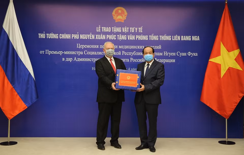 Bộ trưởng, Chủ nhiệm Văn phòng Chính phủ Mai Tiến Dũng trao vật tư y tế cho Đại sứ Liên bang Nga tại Việt Nam Konstantin Vnukov. (Ảnh: Dương Giang/TTXVN)