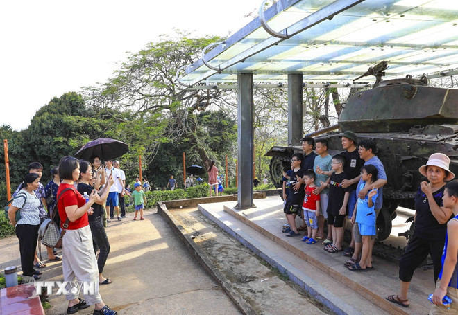 Du khách tham quan, chụp ảnh check in tại Di tích Đồi A1. (Ảnh: Xuân Tư/TTXVN) ttxvn-0704-di-tich-dien-bien-phu.jpg