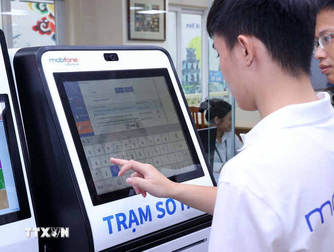 Technisches Personal überprüft den Betrieb der digitalen Station im Bezirkshauptquartier Hoan Kiem. (Foto: Van Diep/VNA) ttxvn-0510-ha-noi-chinh-quyen-2-cap-3.jpg