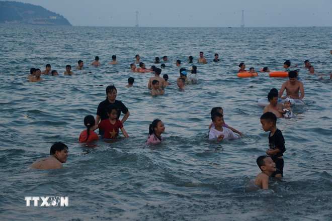 Les touristes aiment jouer et nager dans l'eau bleue claire de la plage de Cua Lo. (Photo : Bich Hue/VNA) ttxvn-0105-cua-lo-2.jpg
