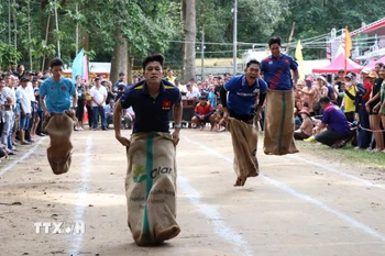 Người dân tham gia trò chơi nhảy bao bố dưới sự cổ vũ của đông đảo khán giả. (Ảnh: Thanh Hòa/TTXVN)