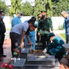 Lực lượng chức năng thực hiện khai quật, lấy mẫu hài cốt liệt sỹ tại các phần mộ chưa xác định thông tin tại Nghĩa trang liệt sỹ xã Cư Jút (tỉnh Lâm Đồng). (Ảnh: Nguyễn Huy Thành/TTXVN)