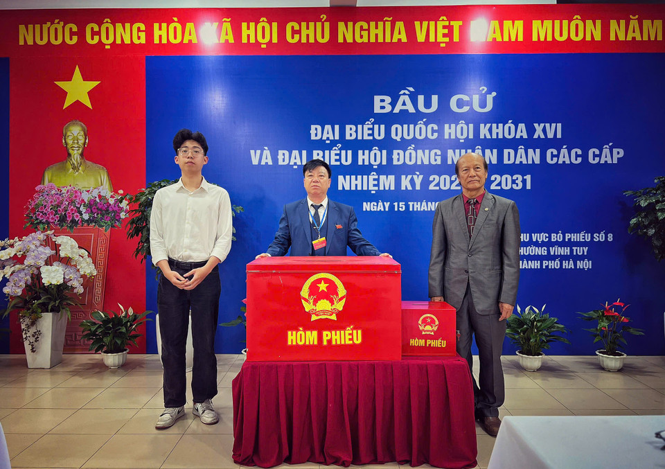 Tổ trưởng Tổ bỏ phiếu số 8, phường Vĩnh Tuy, ông Lễ Sỹ Cường (giữa) cùng hai đại biểu kiểm tra, giám sát hai hòm phiếu gồm một hòm phiếu cố định và một hòm phiếu di động. (Ảnh: Mai Mai/Vietnam+)