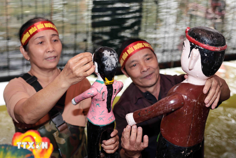 Các nghệ sỹ chuẩn bị kỹ càng cho từng con rối trước mỗi màn biểu diễn để mang đến sự hoàn hảo nhất cho công chúng. (Ảnh: Trần Việt /TTXVN)