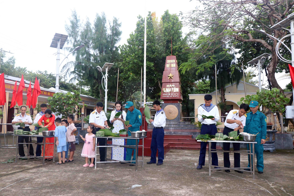 Quân và dân tại đảo Sinh Tồn tham gia gói bánh chưng ngày Tết. (Ảnh: Hữu Quyết/TTXVN)