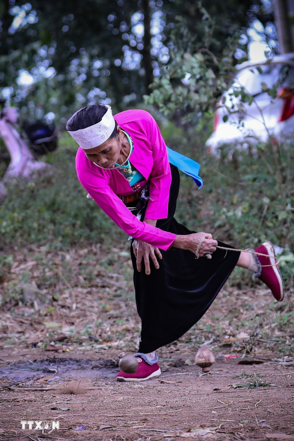 Người phụ nữ Mường khi chơi dùng cù của mình tung mạnh để va vào cù của đối phương khiến cù của đối phương ngừng quay. (Ảnh: Trọng Đạt/TTXVN)