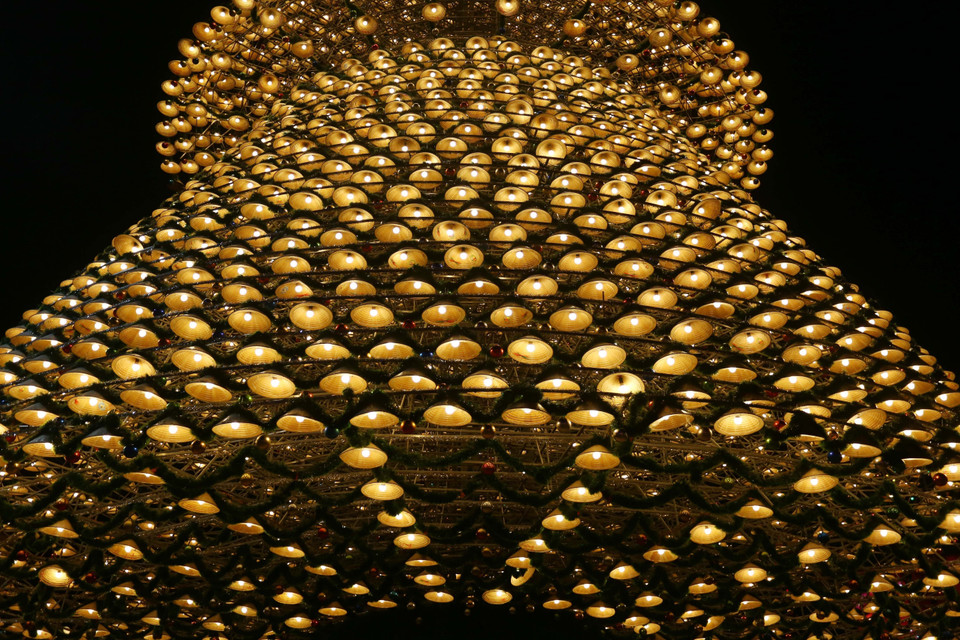 Những chiếc nón lá được xếp đặt khéo léo xung quanh bộ khung sắt nặng hàng tấn, tạo thành hình cây thông Noel 4 tầng lung linh, đặc sắc ở Đồng Nai. (Ảnh: Lê Xuân/TTXVN)