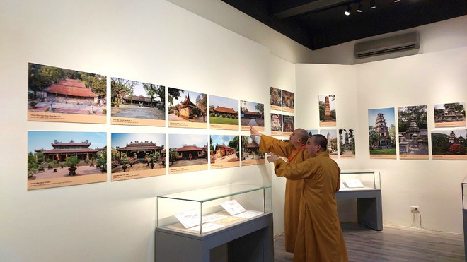 Các hòa thượng tham quan triển lãm Kiến trúc Phật giáo Việt Nam-Thống nhất trong đa dạng. (Ảnh: Minh Thu/Vietnam+) Đẩy nhanh quá trình số hóa di sản kiến trúc và nghệ thuật Phật giáo ảnh 1