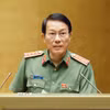 Bộ trưởng Bộ Công an Lương Tam Quang, thừa ủy quyền của Thủ tướng Chính phủ trình bày Tờ trình về 02 dự án: Bộ luật Hình sự (sửa đổi); Luật Tổ chức cơ quan điều tra hình sự (sửa đổi). (Ảnh: Doãn Tấn/TTXVN)