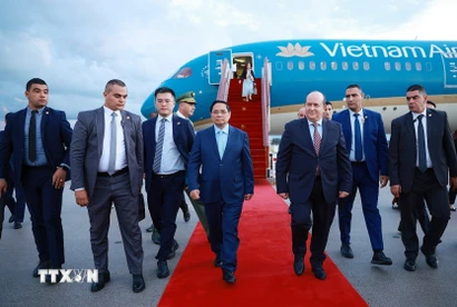 Thủ tướng Cộng hòa Algeria Dân chủ Nhân dân Sifi Ghrieb đón Thủ tướng Phạm Minh Chính tại sân bay quốc tế Houari Boumediene. (Ảnh: Dương Giang/TTXVN)