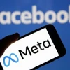 Biểu tượng Meta và Facebook trên màn hình điện thoại thông minh. (Ảnh: Getty Images/TTXVN)