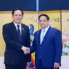 Thủ tướng Phạm Minh Chính gặp Thủ tướng Lào Sonexay Siphandone. (Ảnh: Dương Giang/TTXVN)