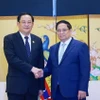 Thủ tướng Phạm Minh Chính gặp Thủ tướng Lào Sonexay Siphandone. (Ảnh: Dương Giang/TTXVN)
