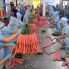 Sản xuất sản phẩm lạp xưởng tại Công ty Vissan. (Ảnh: An Hiếu/TTXVN)