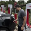 Người dân sạc điện cho ôtô tại một trạm sạc của Tesla ở Arlington, Virginia (Mỹ). (Ảnh: AFP/TTXVN)