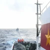 Tàu 471 lai kéo tàu bị nạn của ngư dân về đất liền. (Ảnh: TTXVN phát)