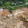 Lực lượng công an, quân đội cùng máy móc cơ giới nỗ lực, khẩn trương tìm kiếm các nạn nhân đang mất tích. (Ảnh: Hoàng Hiếu/TTXVN)