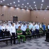 Các bị cáo nghe tòa tuyên án. (Ảnh: Phạm Kiên/TTXVN)