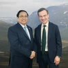 Thủ tướng Phạm Minh Chính gặp Thủ tướng Thụy Điển Ulf Kristersson bên lề Hội nghị COP28. (Ảnh: Dương Giang/TTXVN)