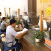 Người dân đến Bộ phận Phục vụ hành chính công xã Việt Thành, huyện Trấn Yên, tỉnh Yên Bái, làm thủ tục hành chính. (Ảnh: Tuấn Anh/TTXVN)