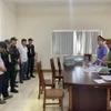 Đọc lệnh bắt đối tượng Vương Viết Thắng và Dương Phúc Hiếu, cán bộ Phòng Tài nguyên Môi trường huyện Hướng Hóa. (Ảnh: TTXVN phát)