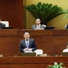 Bộ trưởng Bộ Tài chính Hồ Đức Phớc trả lời chất vấn. (Ảnh: Nhan Sáng/TTXVN)