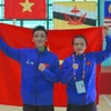 Hai vận động viên Việt Nam đoạt Huy chương Vàng nội dung Seni-Pencak Silat Nguyễn Thành Long và Hoàng Linh Đan. (Ảnh: Văn Dũng/TTXVN)