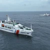 Hai tàu Cảnh sát biển Việt Nam và Indonesia nhận tín hiệu SOS của một tàu đang bị hỏa hoạn, hành trình đến vị trí hỏa hoạn trên biển để dập tắt đám cháy trong chương trình luyện tập chung. (Ảnh: Huỳnh Sơn/TTXVN)