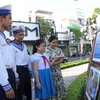 Các chiến sỹ và học sinh xem ảnh tại triển lãm ảnh “Hoàng Sa - Trường Sa trong lòng Quảng Ngãi”. (Ảnh: Đinh Hương/TTXVN)