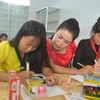 Cô Hoàng Thị Bảy hướng dẫn học sinh làm bài. (Ảnh: Nguyên Dung/TTXVN)