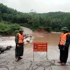 Lực lượng Đồn Biên phòng Ra Mai (Bộ đội Biên phòng tỉnh Quảng Bình) chốt chặn không cho người dân qua các ngầm tràn khi nước lũ dâng cao. (Ảnh: TTXVN phát)