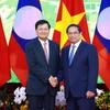 Thủ tướng Phạm Minh Chính hội kiến Tổng Bí thư, Chủ tịch nước Lào Thongloun Sisoulith. (Ảnh: Dương Giang/TTXVN)