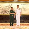Đại tướng Phan Văn Giang và Thượng tướng Đổng Quân, Bộ trưởng Bộ Quốc phòng Trung Quốc. (Ảnh: TTXVN phát)