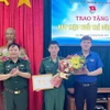 Phó Bí thư Thường trực Tỉnh đoàn, Phó Chủ tịch Hội Liên hiệp thanh niên Việt Nam tỉnh Cao Bằng Hà Ngọc Huy trao tặng Huy hiệu “Tuổi trẻ dũng cảm” cho Binh nhất Lý Văn Vũ. (Ảnh: TTXVN phát)