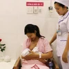Sản phụ được hướng dẫn cách cho bé bú đúng cách trong một giờ sau khi sinh. (Nguồn: TTXVN) 