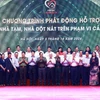 Thủ tướng Phạm Minh Chính với các đại diện các tổ chức, doanh nghiệp hỗ trợ kinh phí xóa nhà tạm, nhà dột nát. (Ảnh: Dương Giang/TTXVN)