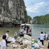 Các tình nguyện viên tham gia hoạt động dọn rác trên Vịnh Hạ Long. (Ảnh: CTV/Vietnam+)