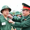 Lễ giao nhận quân ở Quảng Bình diễn ra trang trọng, nhanh gọn, tiết kiệm, an toàn, đúng quy định. (Ảnh: TTXVN phát)