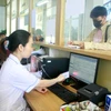 Khám chữa bệnh bảo hiểm y tế bằng căn cước công dân gắn chip tại Trung tâm Y tế huyện Gia Viễn, tỉnh Ninh Bình. (Ảnh: Thùy Dung/TTXVN)
