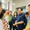 Phó Chủ tịch Quốc hội Trần Quang Phương (đeo kính) trao đổi về tình hình vụ cháy và thăm hỏi sức khỏe các nạn nhân đang điều trị tại Bệnh viện Giao thông Vận tải vào sáng 24/5. (Ảnh: Tuyết Mai/TTXVN)