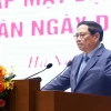 Thủ tướng Phạm Minh Chính phát biểu tại buổi gặp mặt đại diện doanh nghiệp nhân Ngày Doanh nhân Việt Nam (13/10). (Ảnh: Dương Giang/TTXVN)