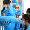 Việt Nam trải qua 2 giai đoạn chống dịch COVID-19 với 4 đợt bùng phát dịch. (Ảnh: TTXVN/Vietnam+)